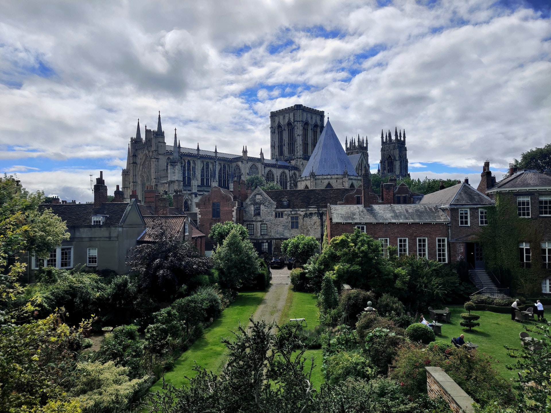photo of historic york minster in england surrounded with trees and grass