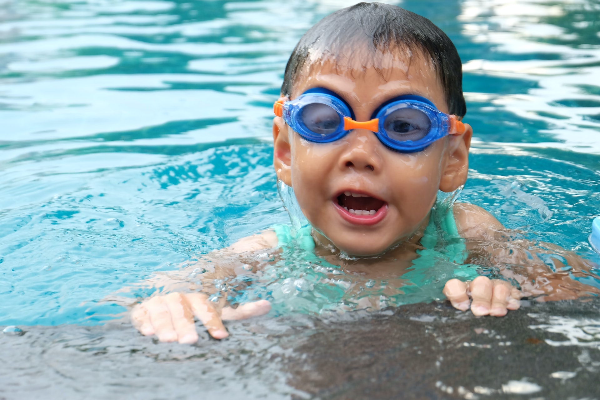 Toddler swimming in pool
