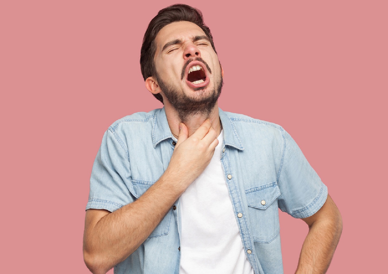 Young bearded man is chocking and make painful face.