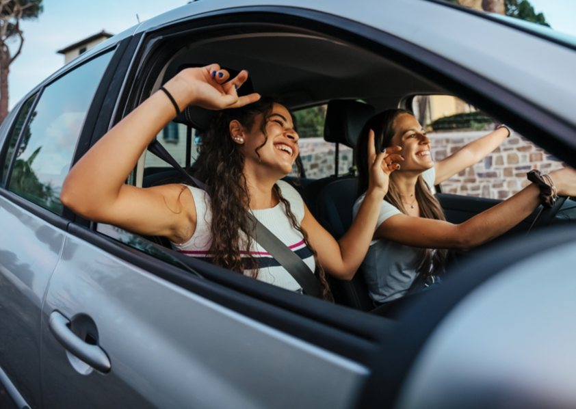 Best friends having fun together driving
