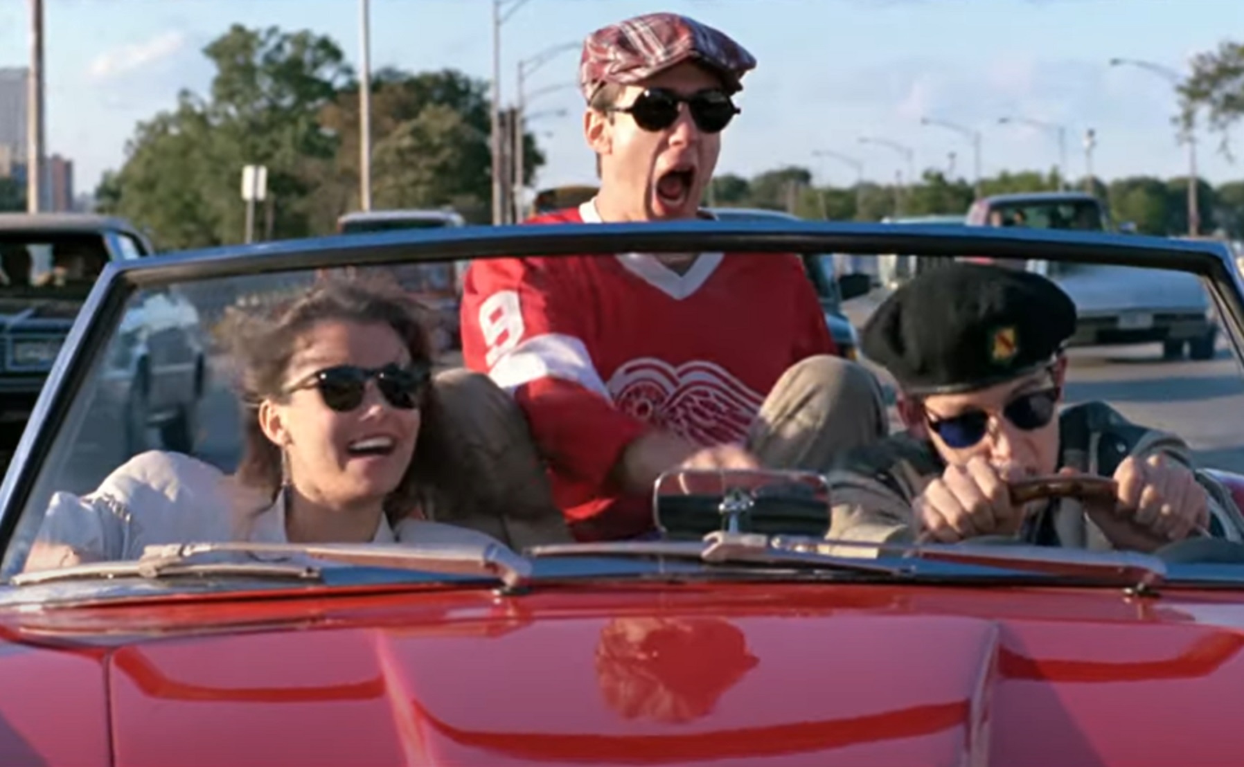 Ferris Bueller's Day Off - actors are driving in red car with open top ,looking happy - from Ferris Bueller's Day Off (1986)