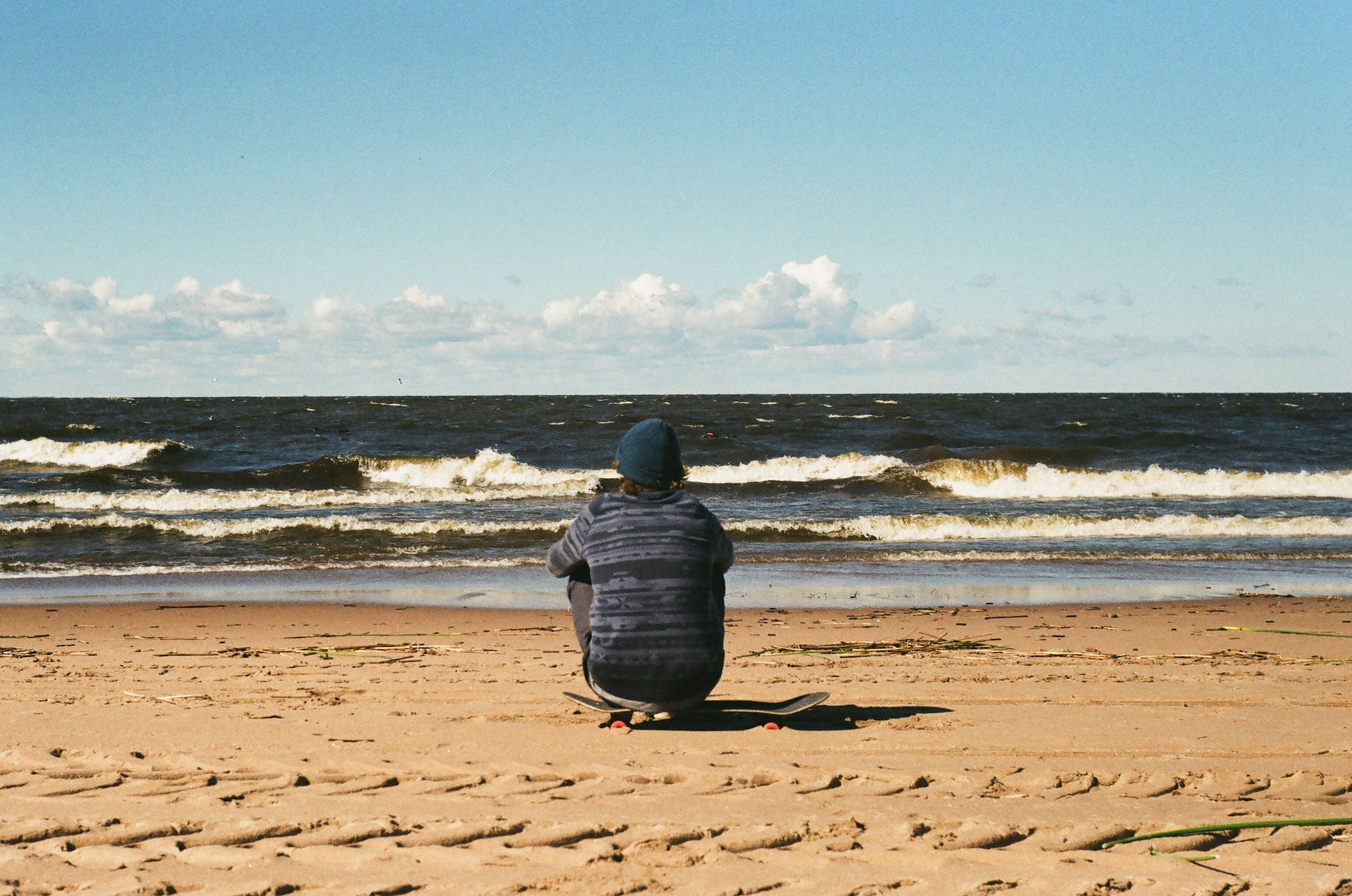 Person sitting in sand