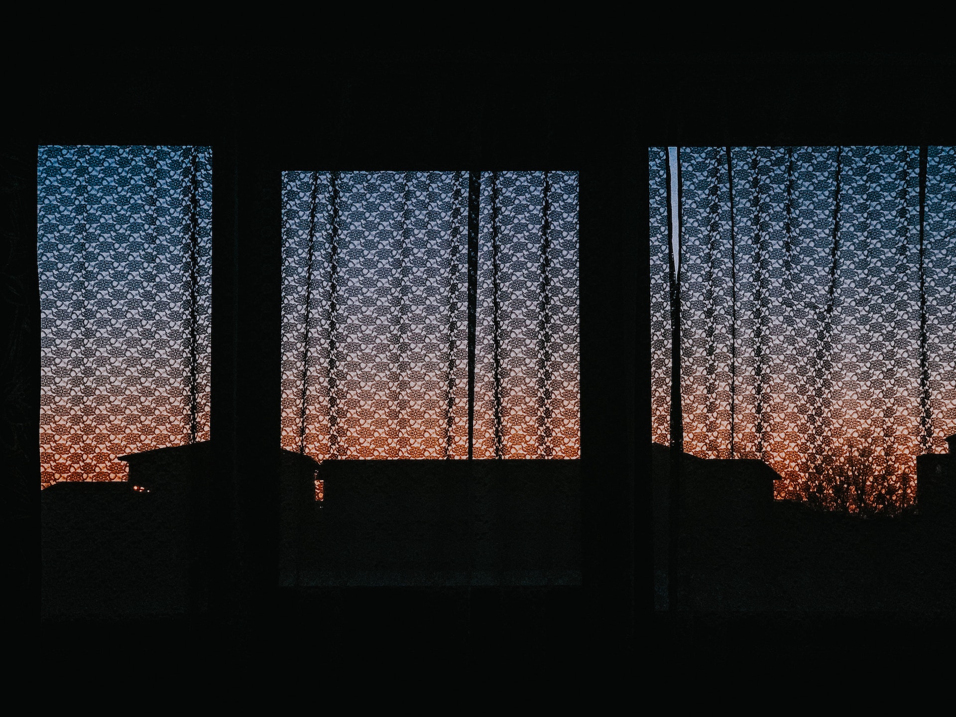 dark silhouetted windows and curtains