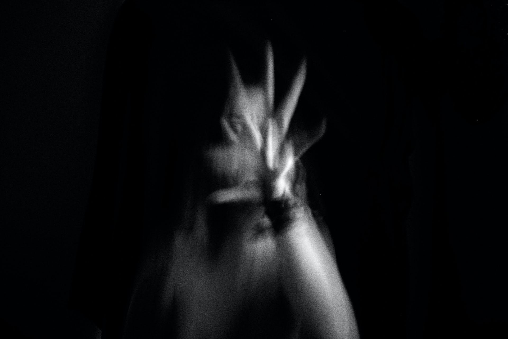 blurred motion of woman with her hand up