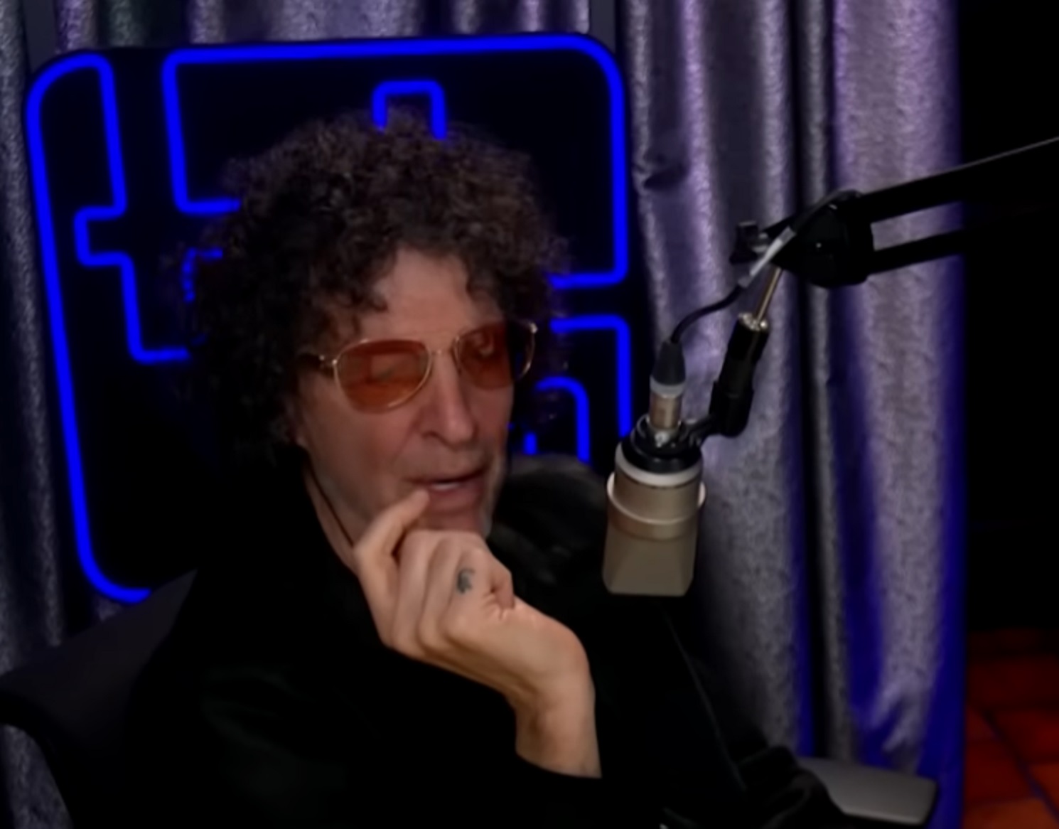 Screenshot of Howard Stern talking on the microphone - from The Howard Stern Show