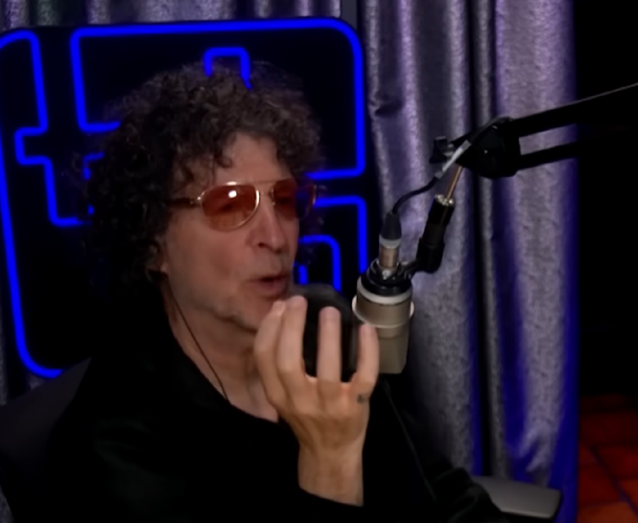 Screenshot of Howard Stern talking on the microphone - from The Howard Stern Show