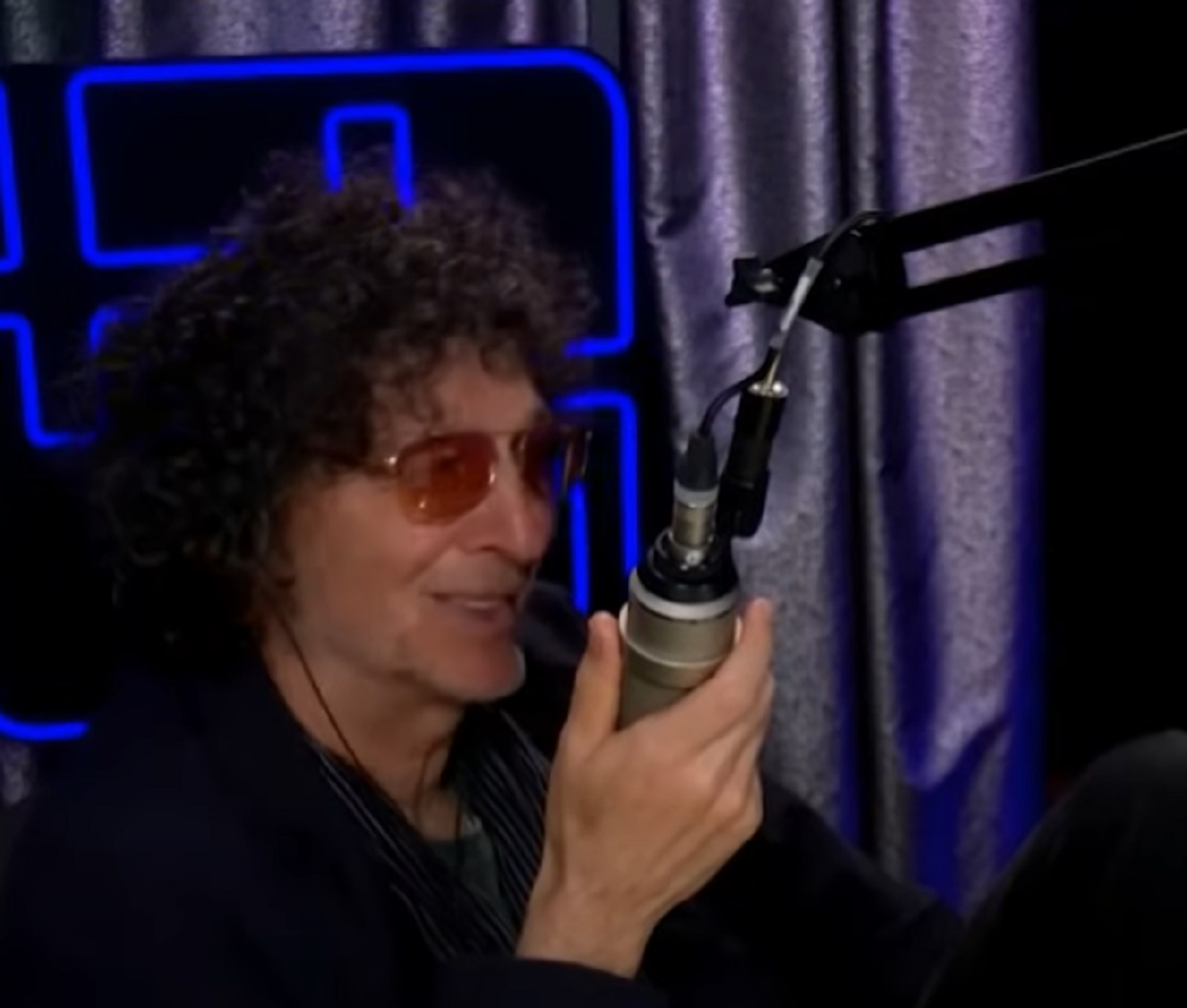 Screenshot of Howard Stern talking on the microphone - from The Howard Stern Show
