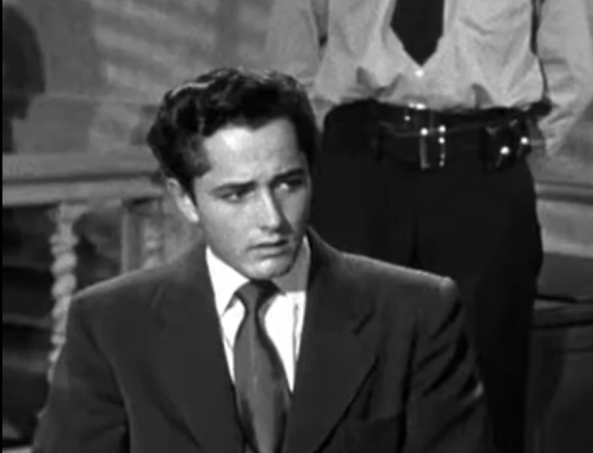 Screenshot of John Derek wearing suit and tie - from Knock On Any Door (1949)