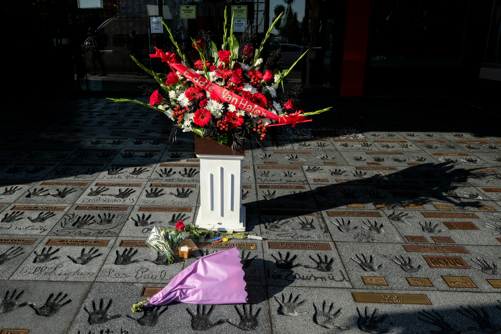 Flowers, candle and cigarette are placed at Eddie Van Halen’s hand prints
