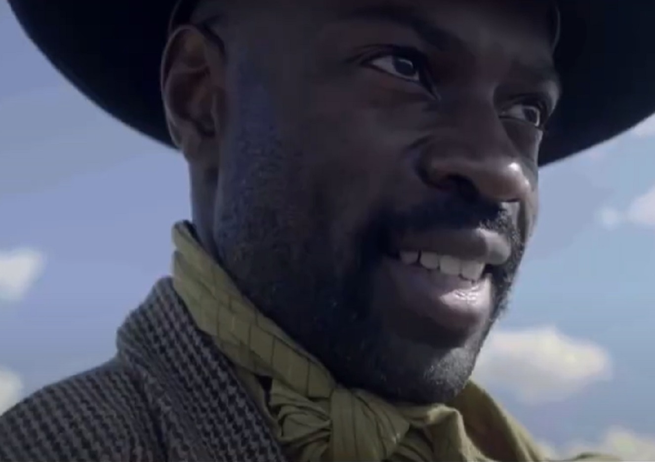 Screenshot: Bass Reeves wearing brown jacket and hat standing outside - from H.e.l.l on the Border (2019)