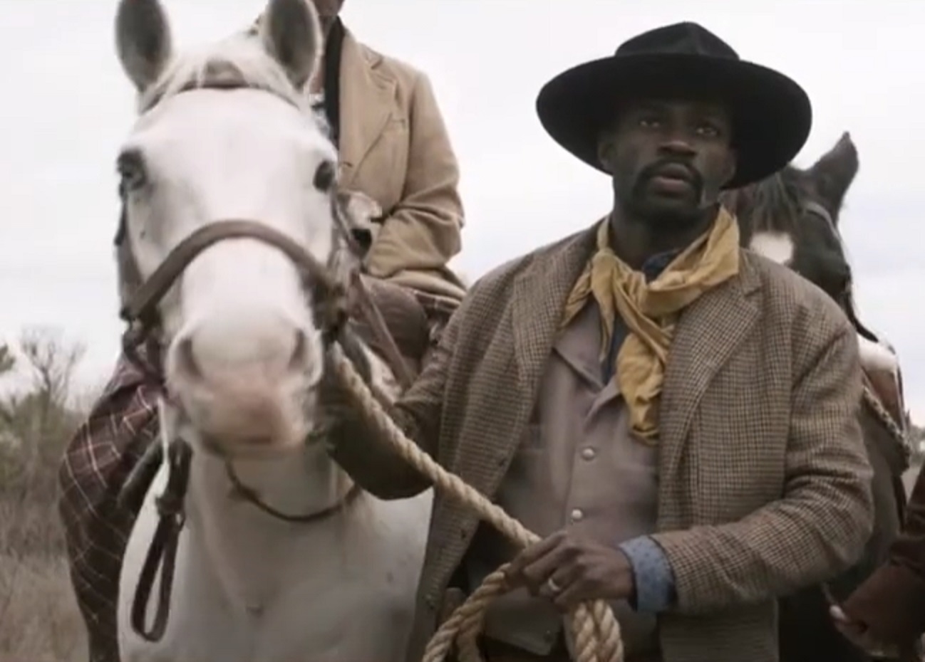 Screenshot: Bass Reeves wearing brown jacket and hat standing outside - from H.e.l.l on the Border (2019)