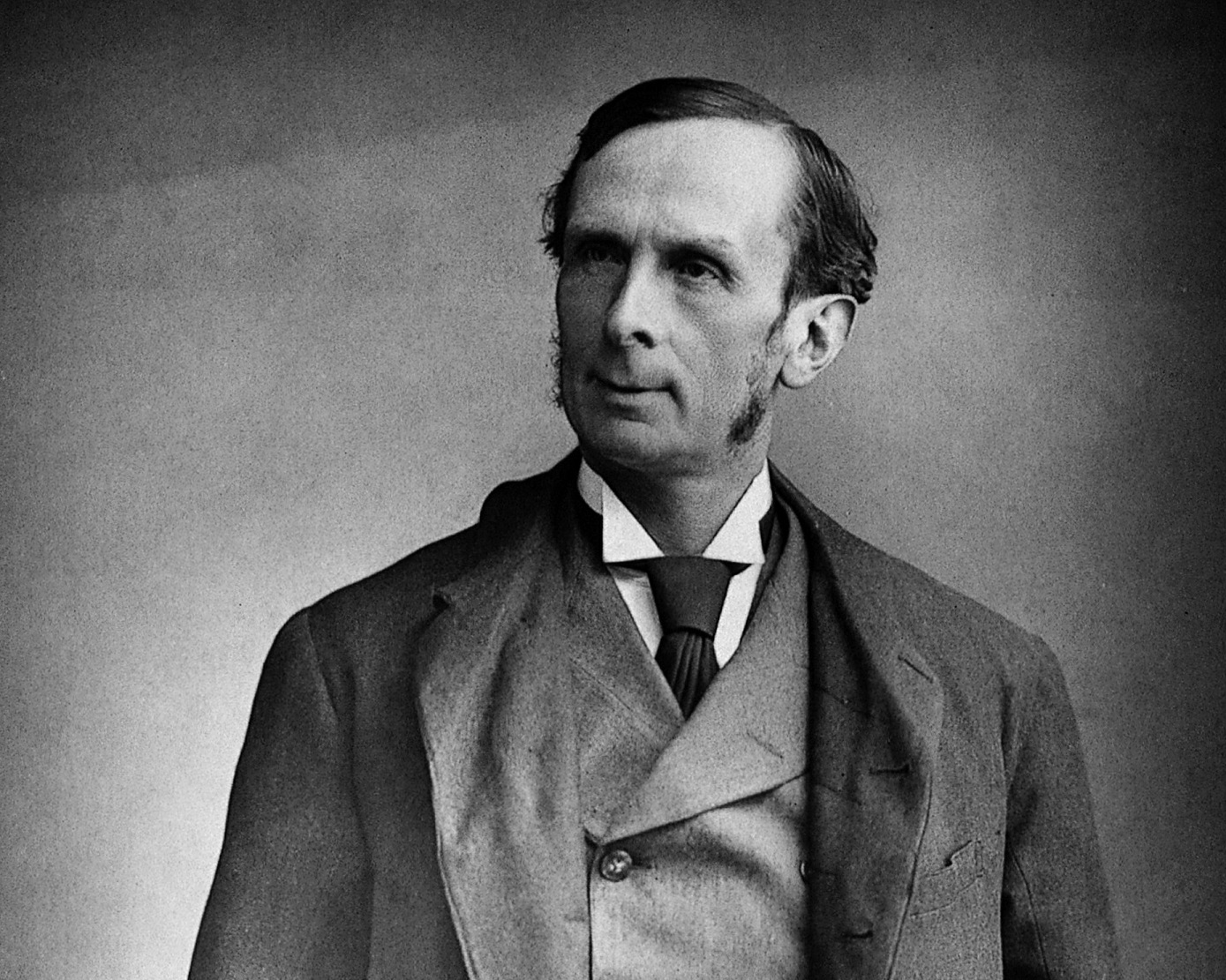 B&W Portrait of Morell Mackenzie wearing suit and looking at side.