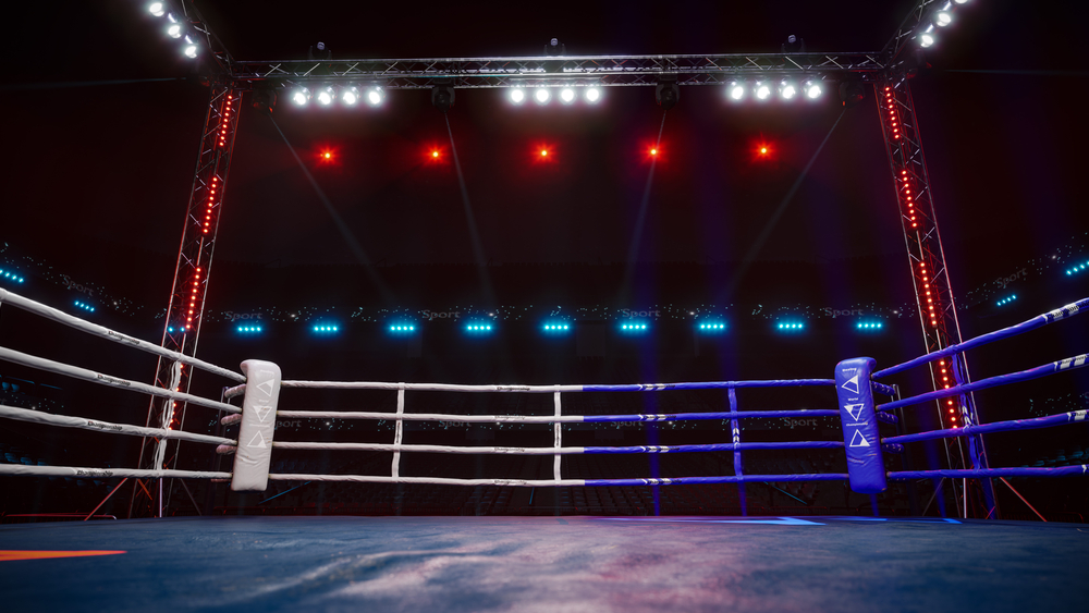 Empty boxing arena with red and white lights above