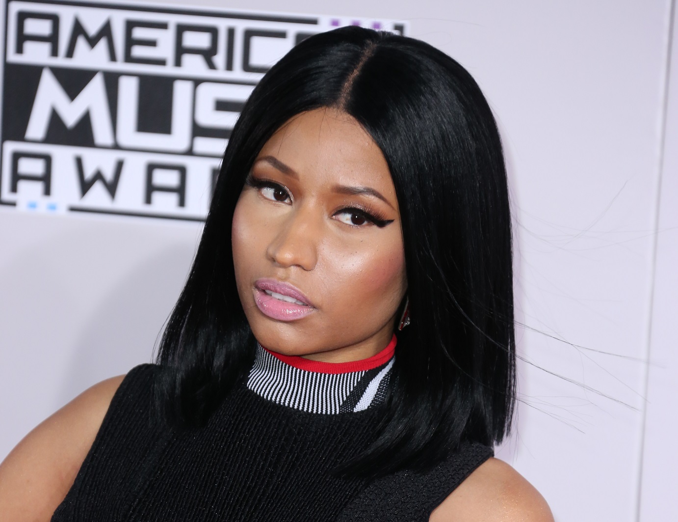 Nicky Minaj wearing black dress is looking at side - 2014