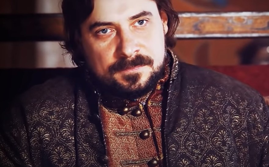 Ivan III of Russia, actor Evgeniy Tsyganov sitting on throne