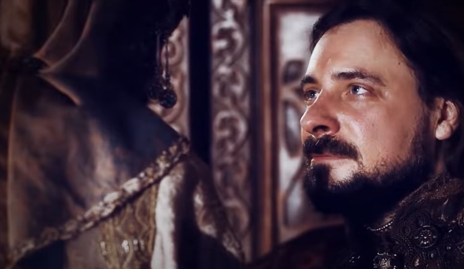 Ivan III of Russia, actor Evgeniy Tsyganov sitting on throne