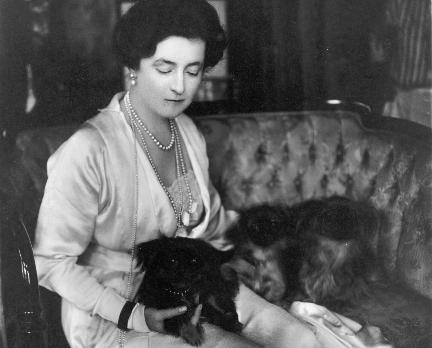Lady Lucy Duff-Gordon seated, facing right with lapdogs - 1916