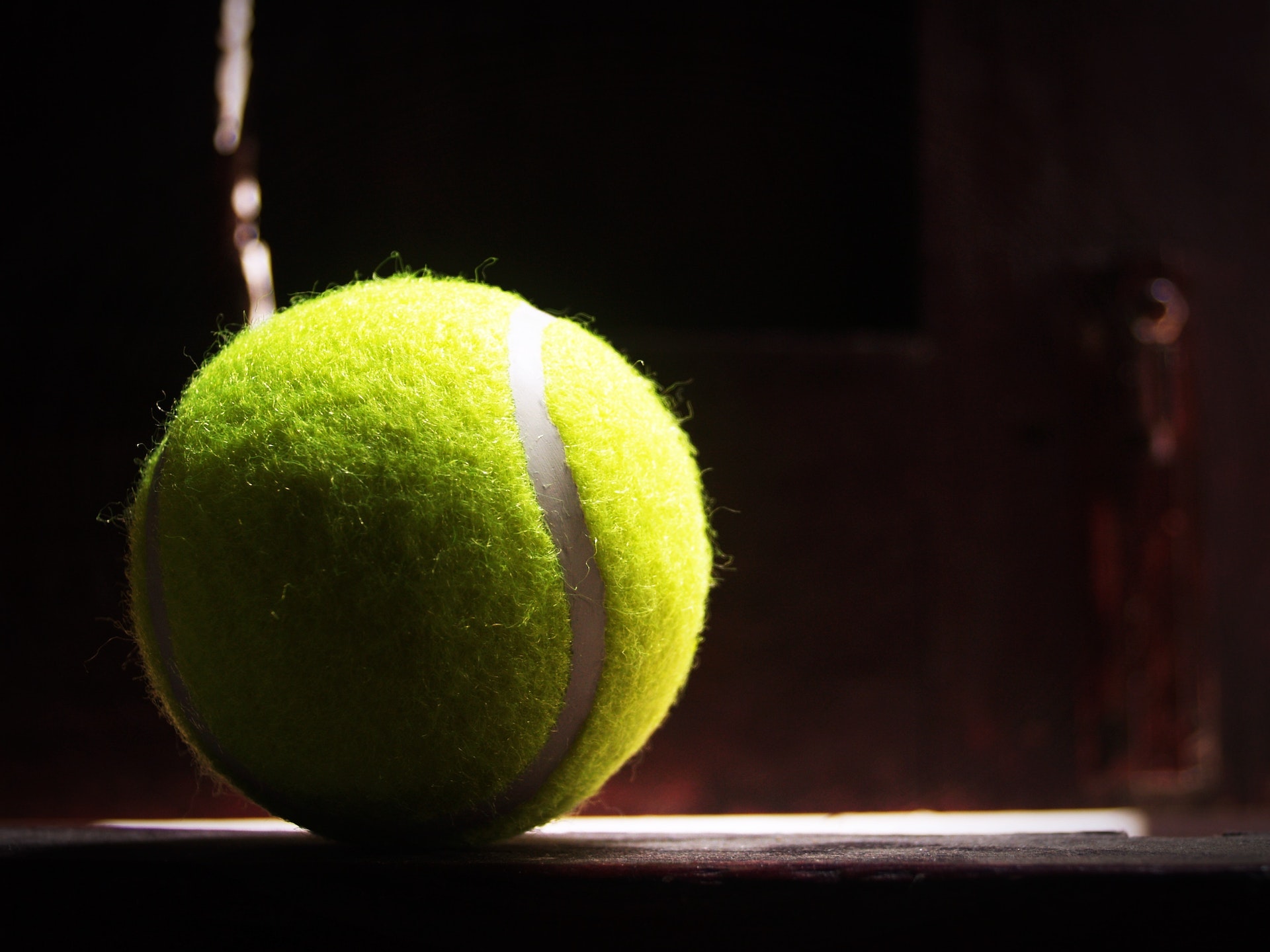close-up of a tennis ball on a dark background