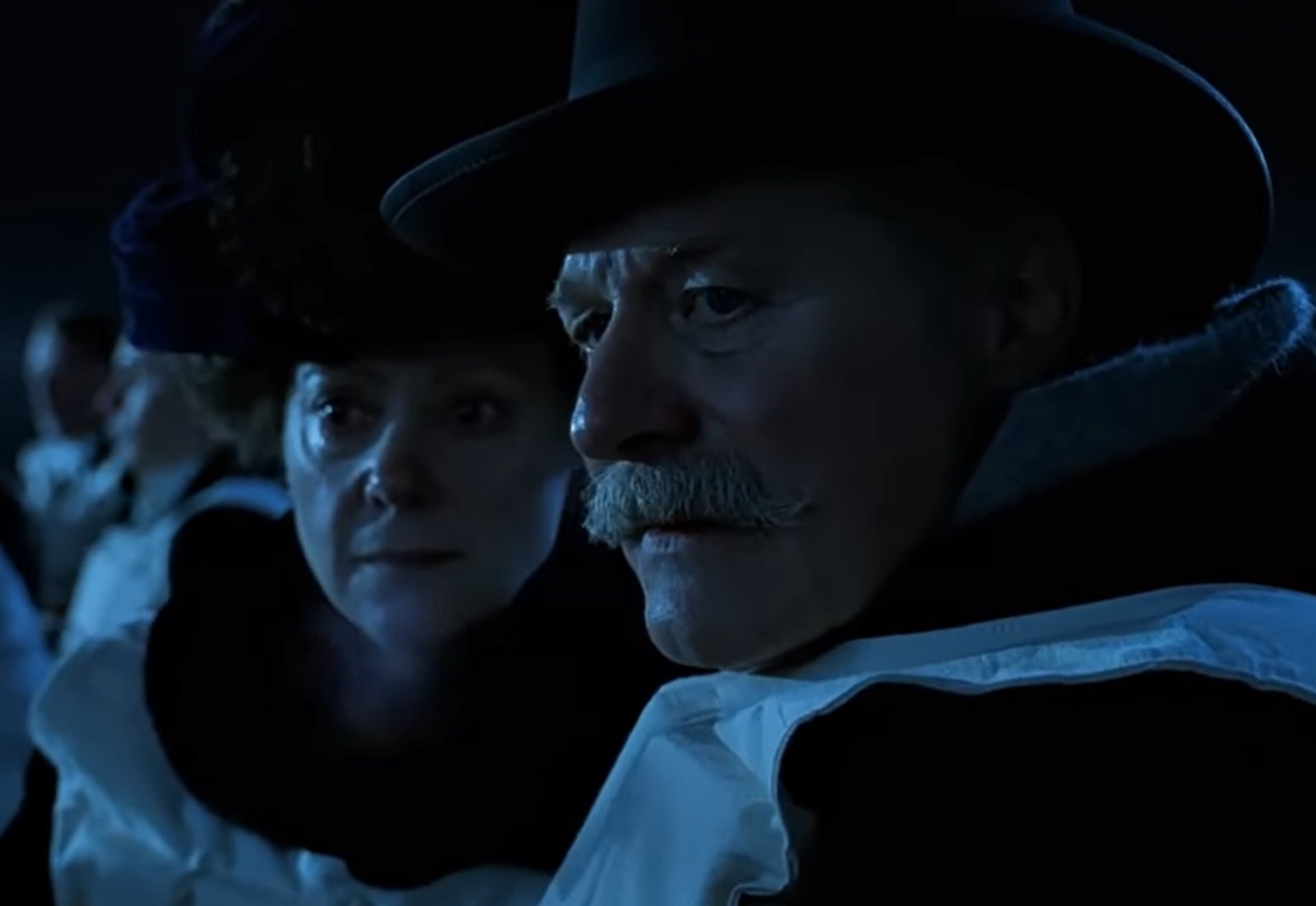 Screenshot: Lady Duff-Gordon and Cosmo Duff-Gordon are looking at side- from Titanic (1997)