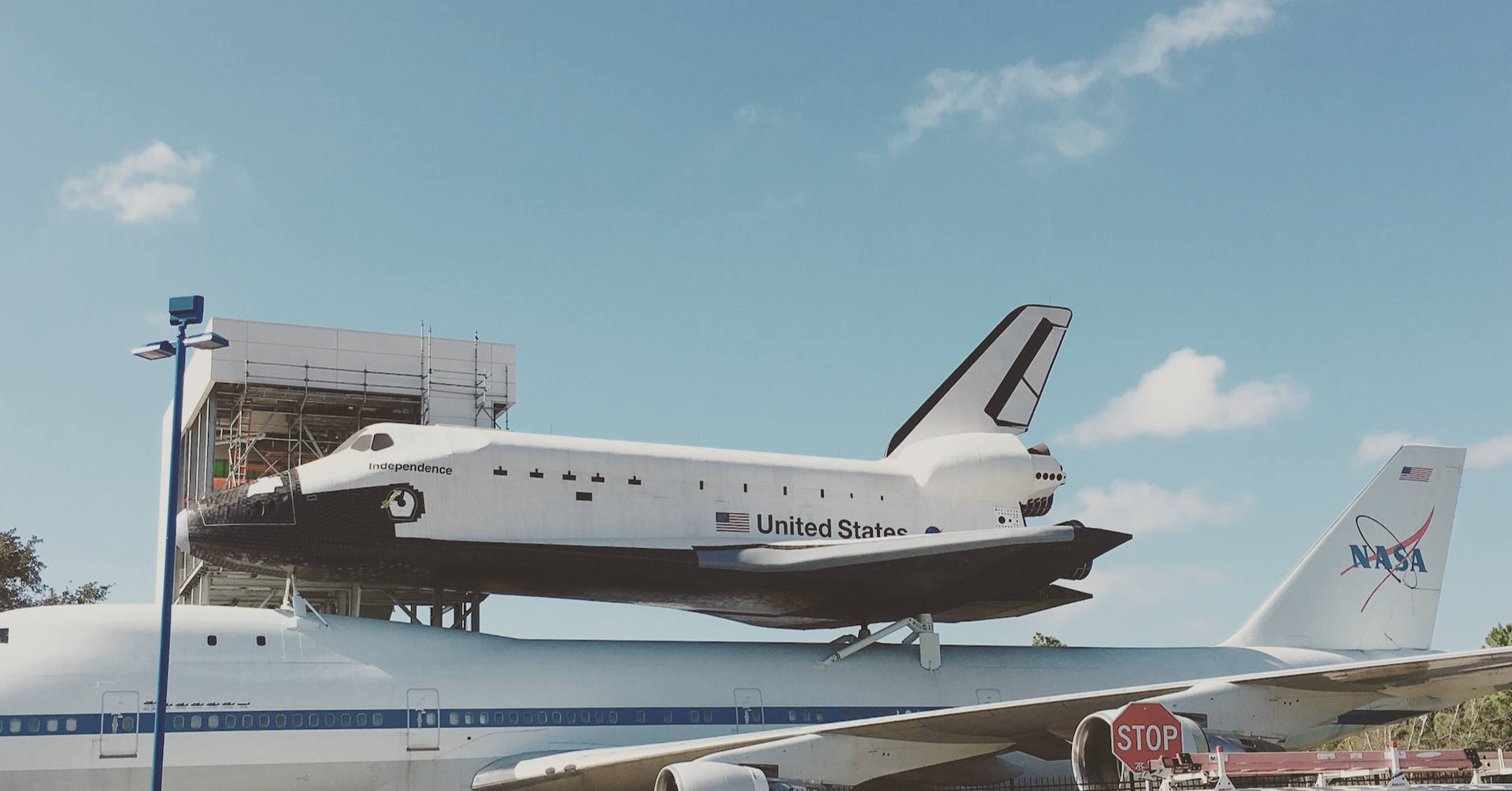 photo of gray airplane carrying a space shuttle