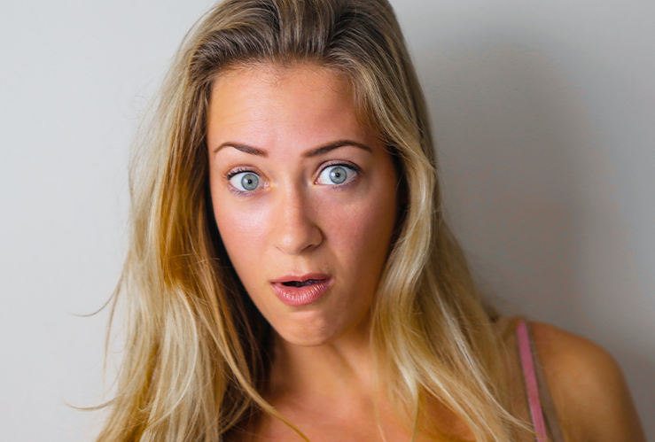 blonde girl with blue eyes looking confused
