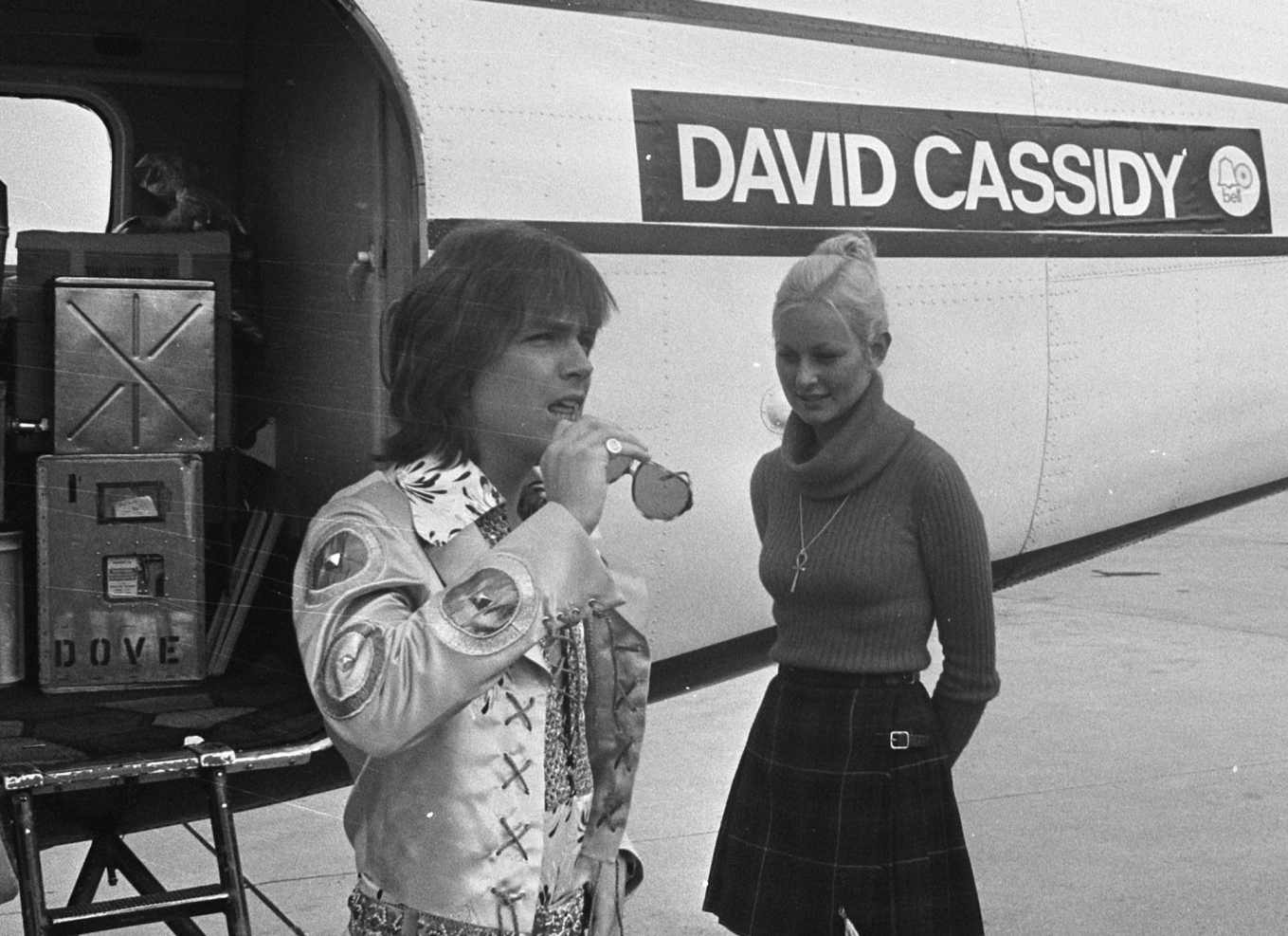 David Cassidy is standing outside next to a plane with his name on it - 1972