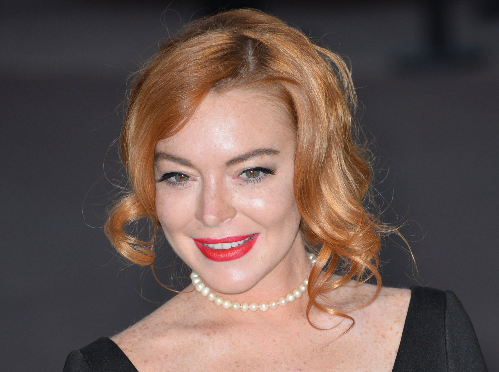 Lindsay Lohan at the 24th amfAR Gala Cannes at the Hotel du Cap-Eden-Roc, Antibes in black dress