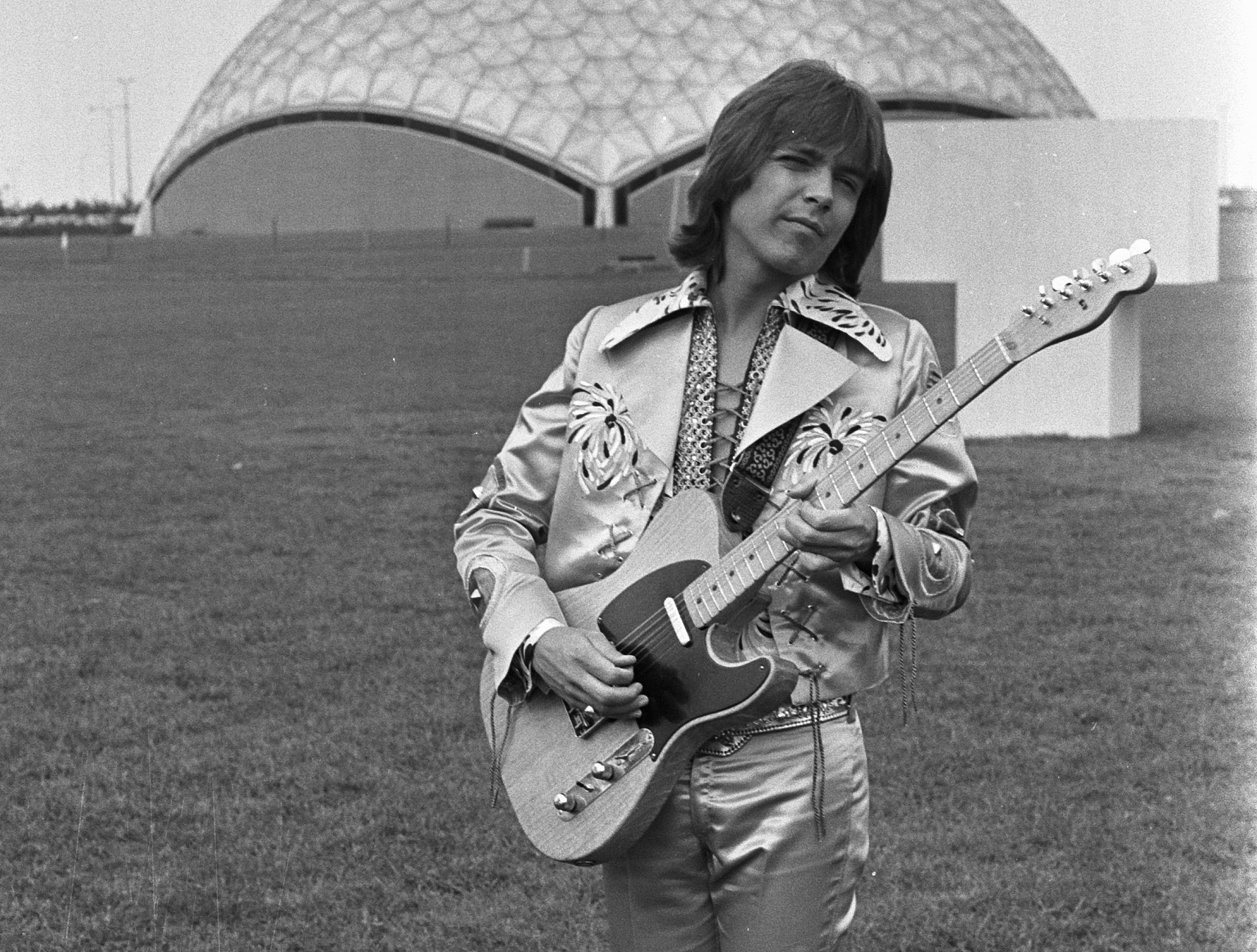 David Cassidy wearing jacket and playing on guitar outside - 1972