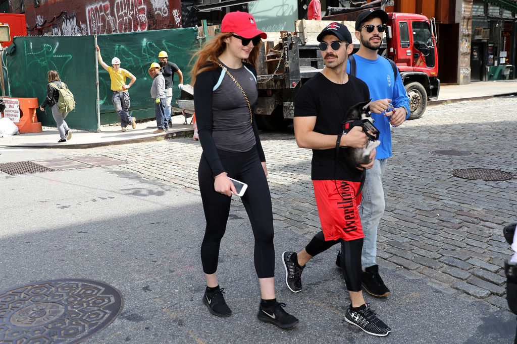 Sophie Turner and her boyfriend Joe Jonas are seen walking puppy Husky Dog in sports wear