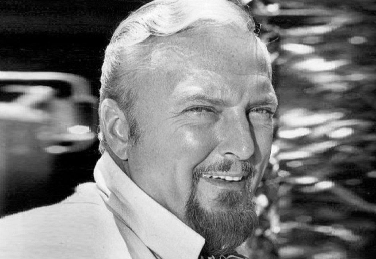 Jack Cassidy wearing white shirt is smiling at camera - 1973