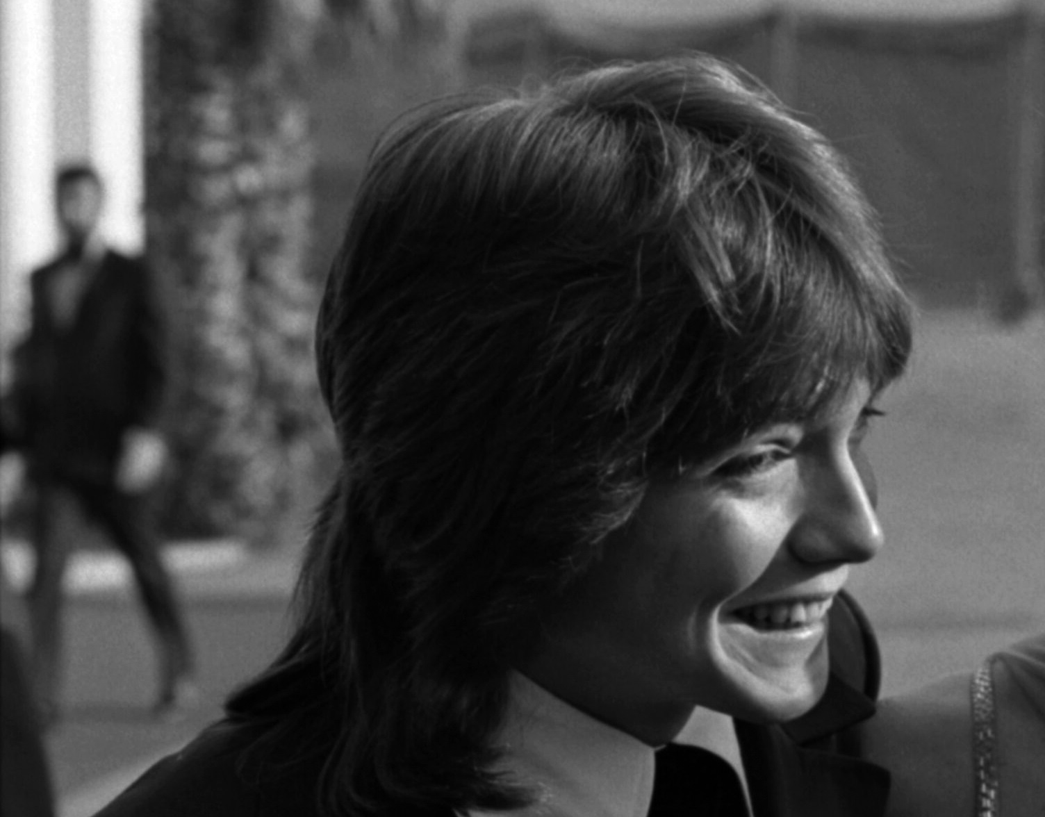 David Cassidy wearing black suit is looking at side and smiling - 1971