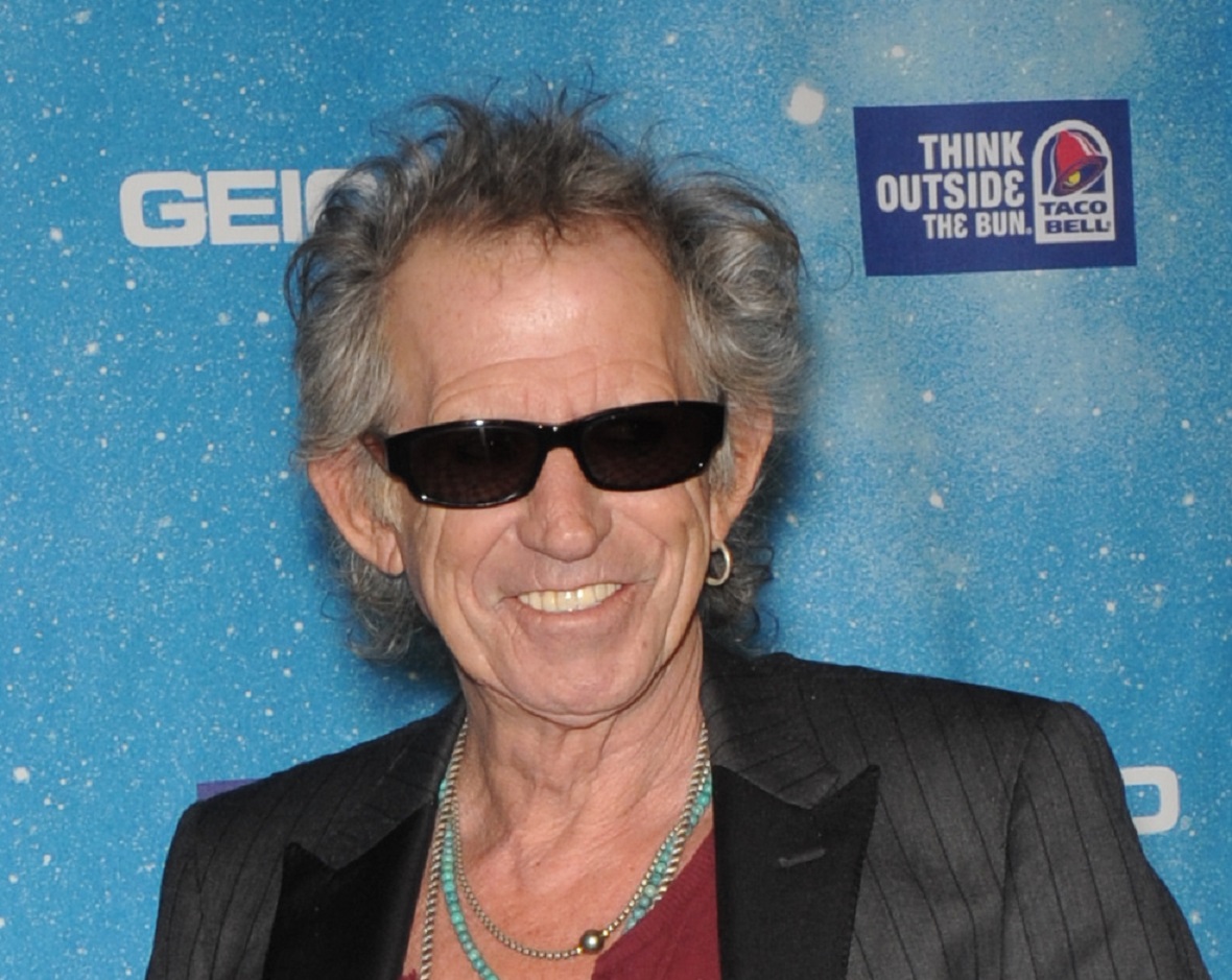 Keith Richards wearing black jacket and glasses looking at camera and smiling - 2009
