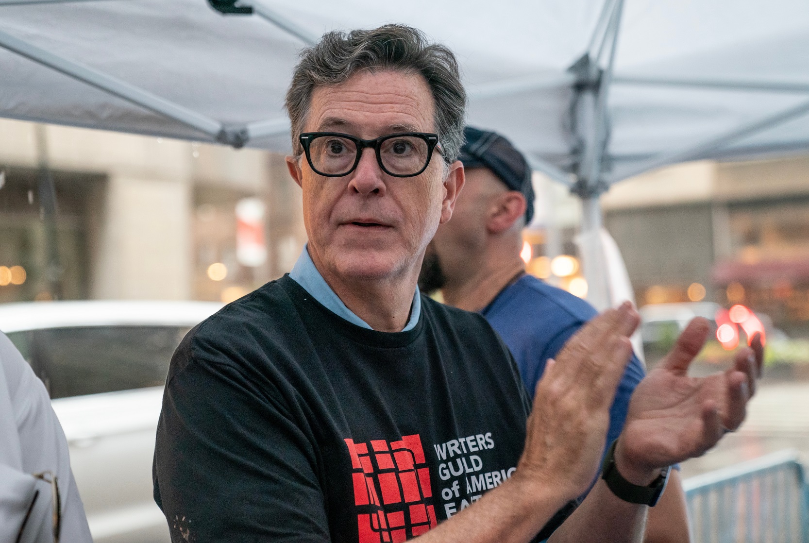 Stephen Colbert wearing black shirt looking at side - 2023