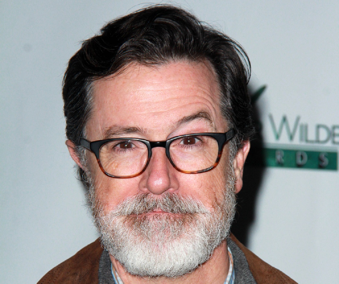 Stephen Colbert with bear and glasses is looking at camera - 2019