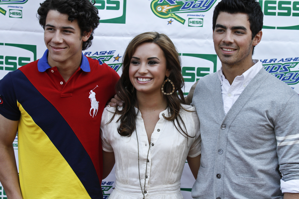The Jonas Brothers (L-R) Nick, Joe and singer Demi Lovato arrive at the Arthur Ashe Kids Day at US Open August 28, 2010 in New York City