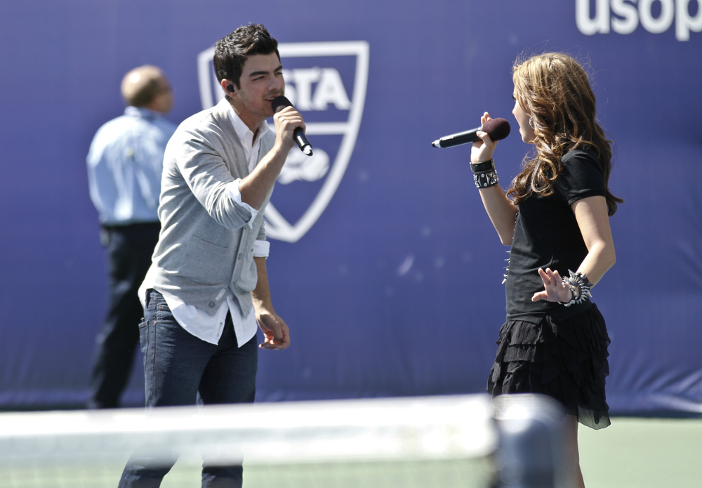 Singer Demi Lovato and Joe Jonas perform at Arthur Ash stadium