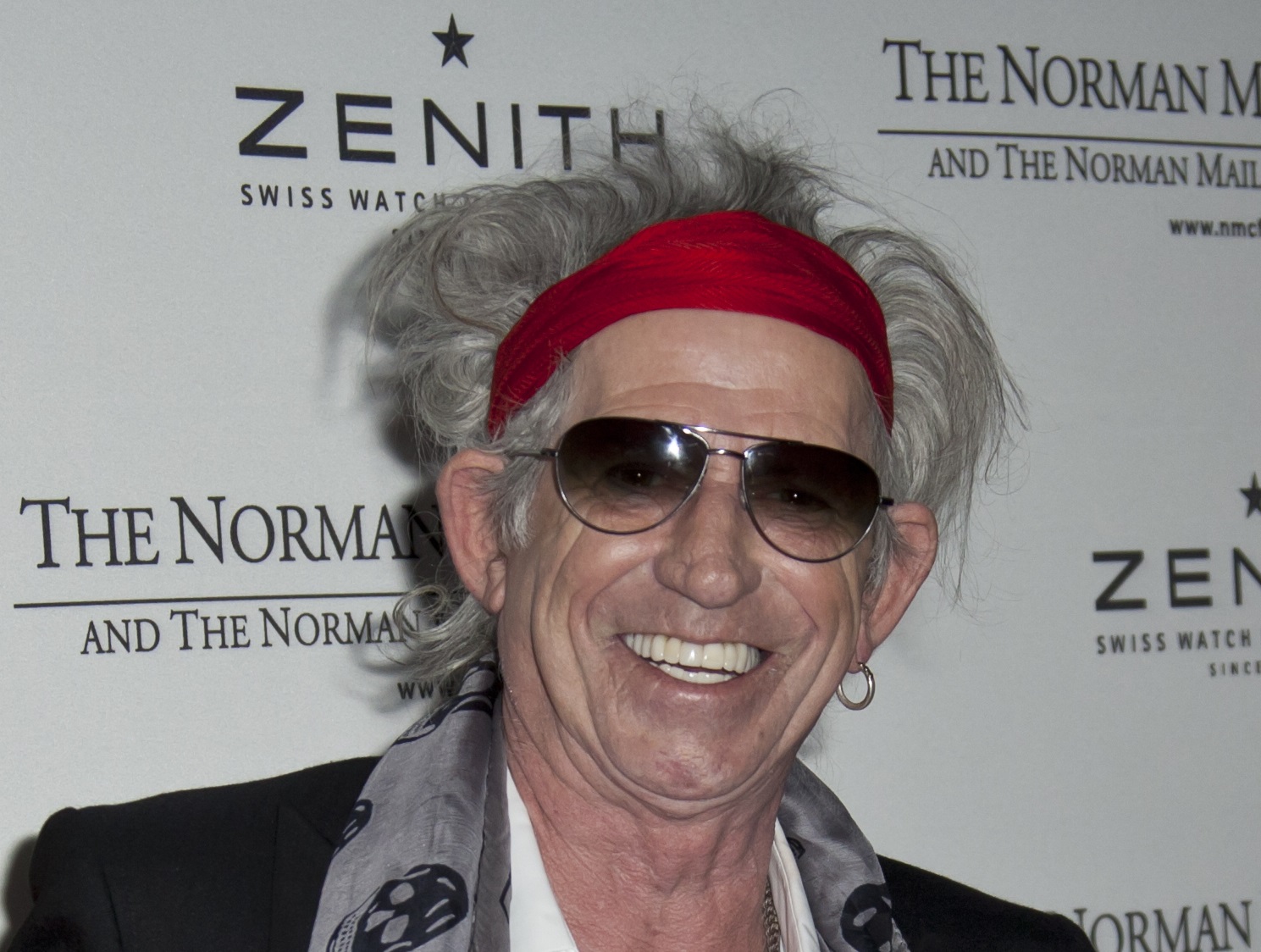 Keith Richards wearing red bandana and gasses is smiling at camera - 2011