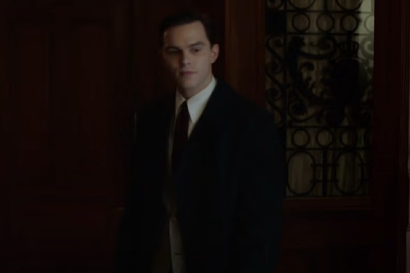 Screenshot: J.D. Salinger wearing dark suit is looking at side - from Rebel in the Rye (2017)