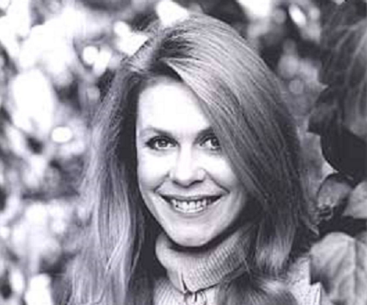 B&W portrait of Elizabeth Montgomery looking and smiling at camera.