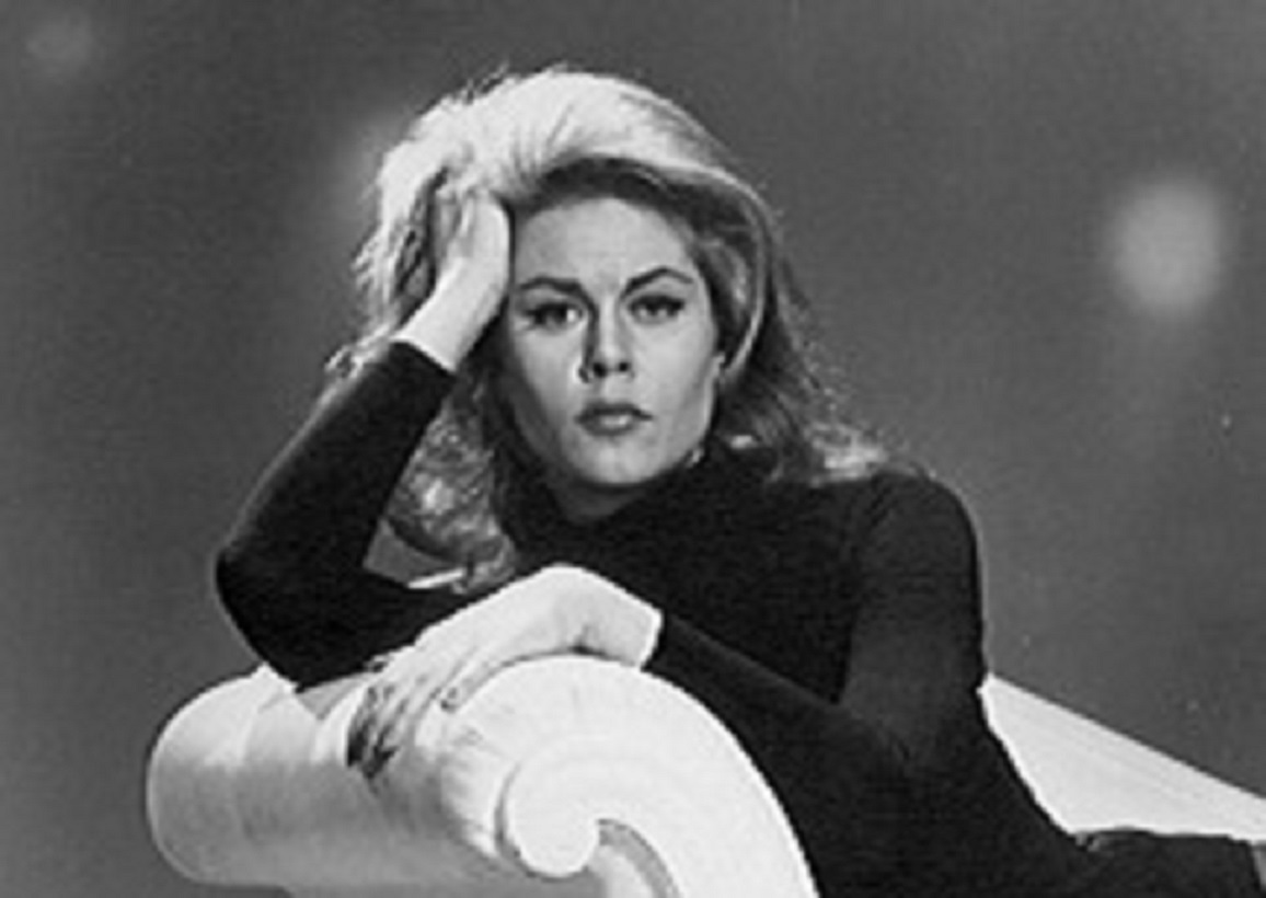 B&W portrait of Elizabeth Montgomery in black dress looking at camera.