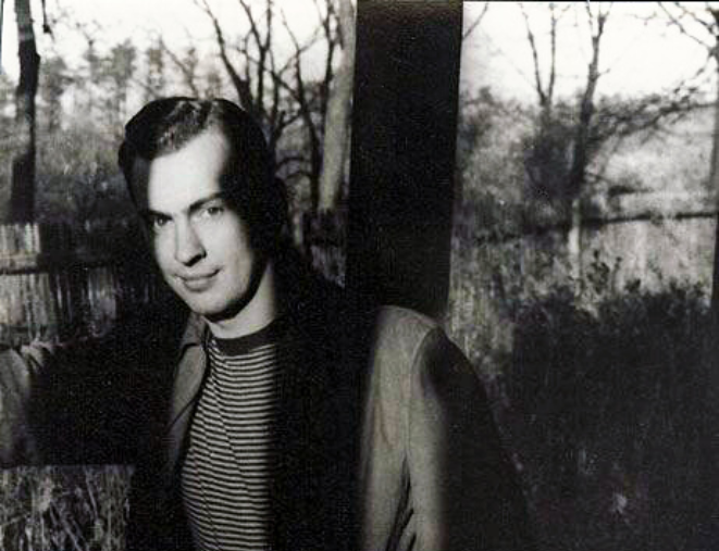 Grayscale Outdoor Photo Of Gore Vidal partially covered with shadows wearing a long jacket