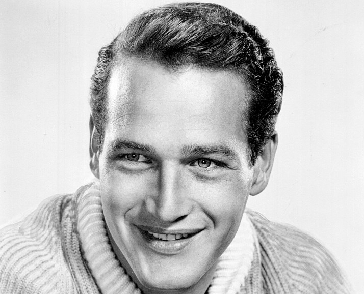 Grayscale Portrait Photo Of The Actor Paul Newman wearing a light colored sweater and smiling