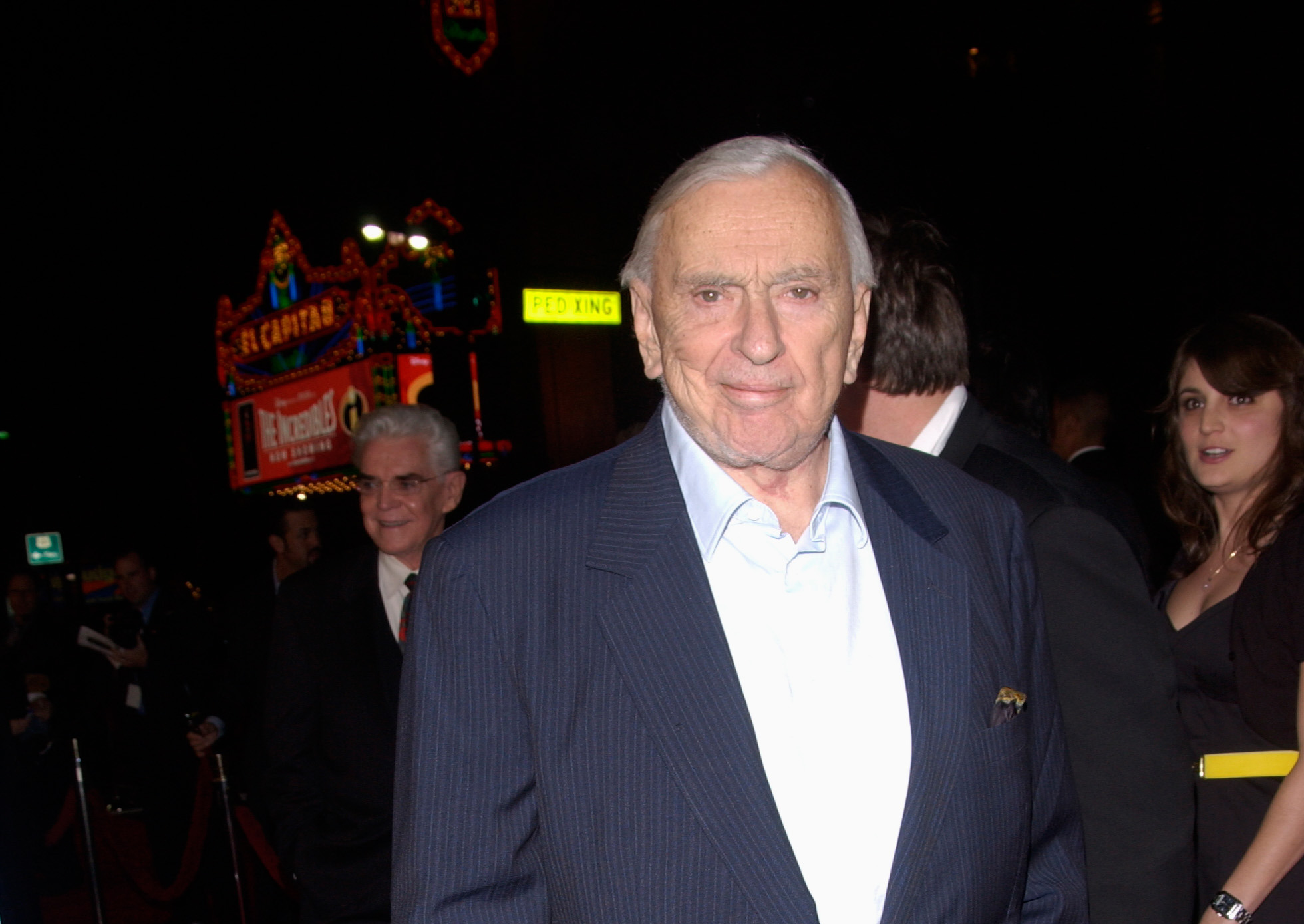Writer Gore Vidal at the world premiere in Hollywood wearing a dark blue suit and light blue shirt