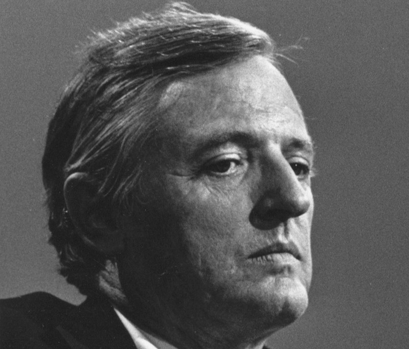 Grayscale Portrait Photo Of William F. Buckley Jr. wearing a dark suit white shirt