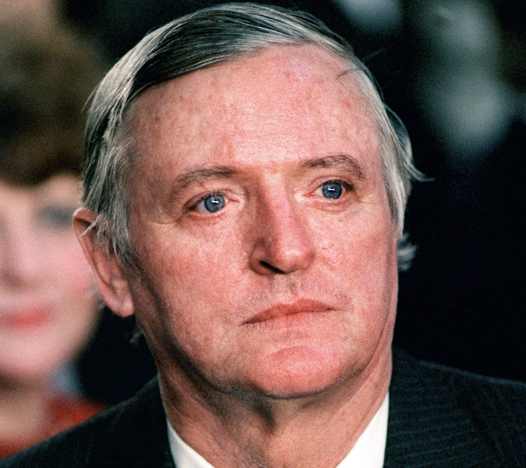 Portrait Photo Of  William F. Buckley Jr wearing a blacck suit white shirt and gray tie