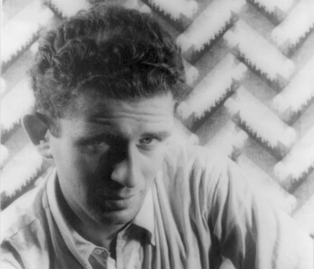 Grayscale Portrait Photo Of Norman Mailer wearing a white shirt facing the camera