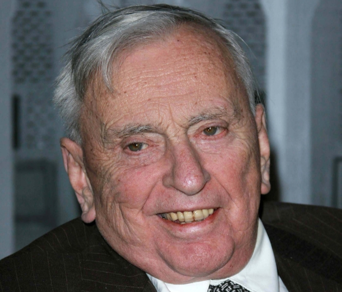Gore Vidal at the Giorgio Armani Prive Show to celebrate the Oscars wearing a black suit white shirt