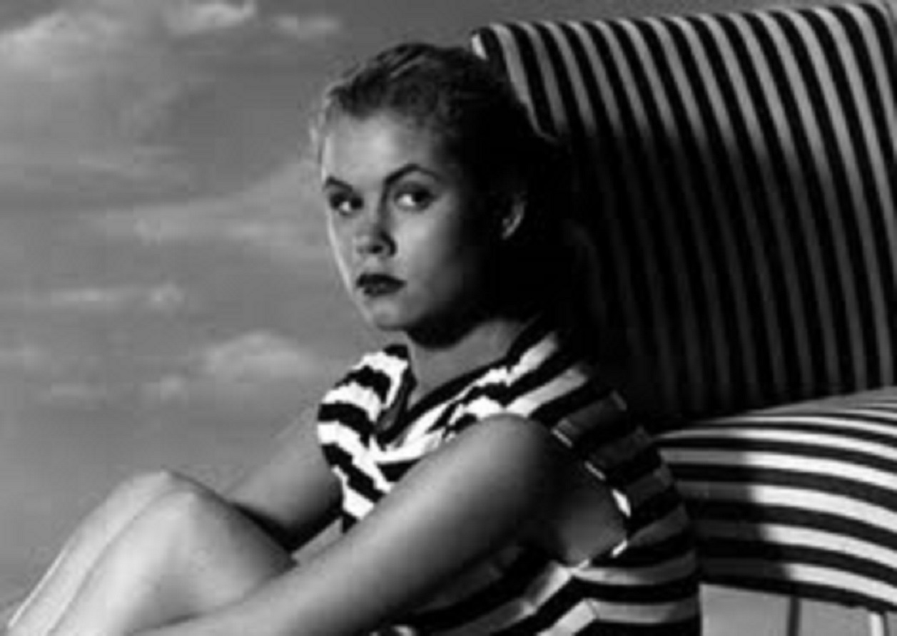 Elizabeth Montgomery in B&W dress looking at camera.