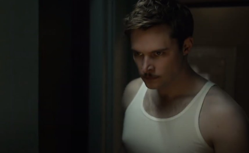 Jack Reynor as Jack Parsons in Strange Angel in white t-shirt
