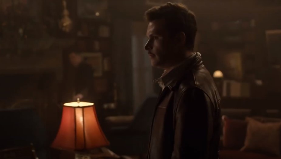 Jack Reynor as Jack Parsons in leather jacket looking at left